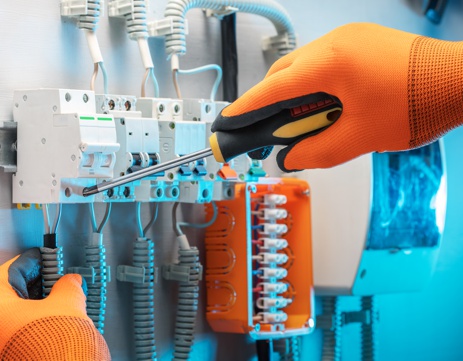 Electrician is repairing the switchboard voltage. Close-up of Electrician at work.